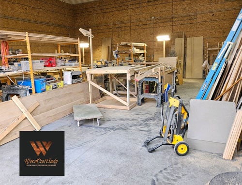 a woodworking shop with a blue lift